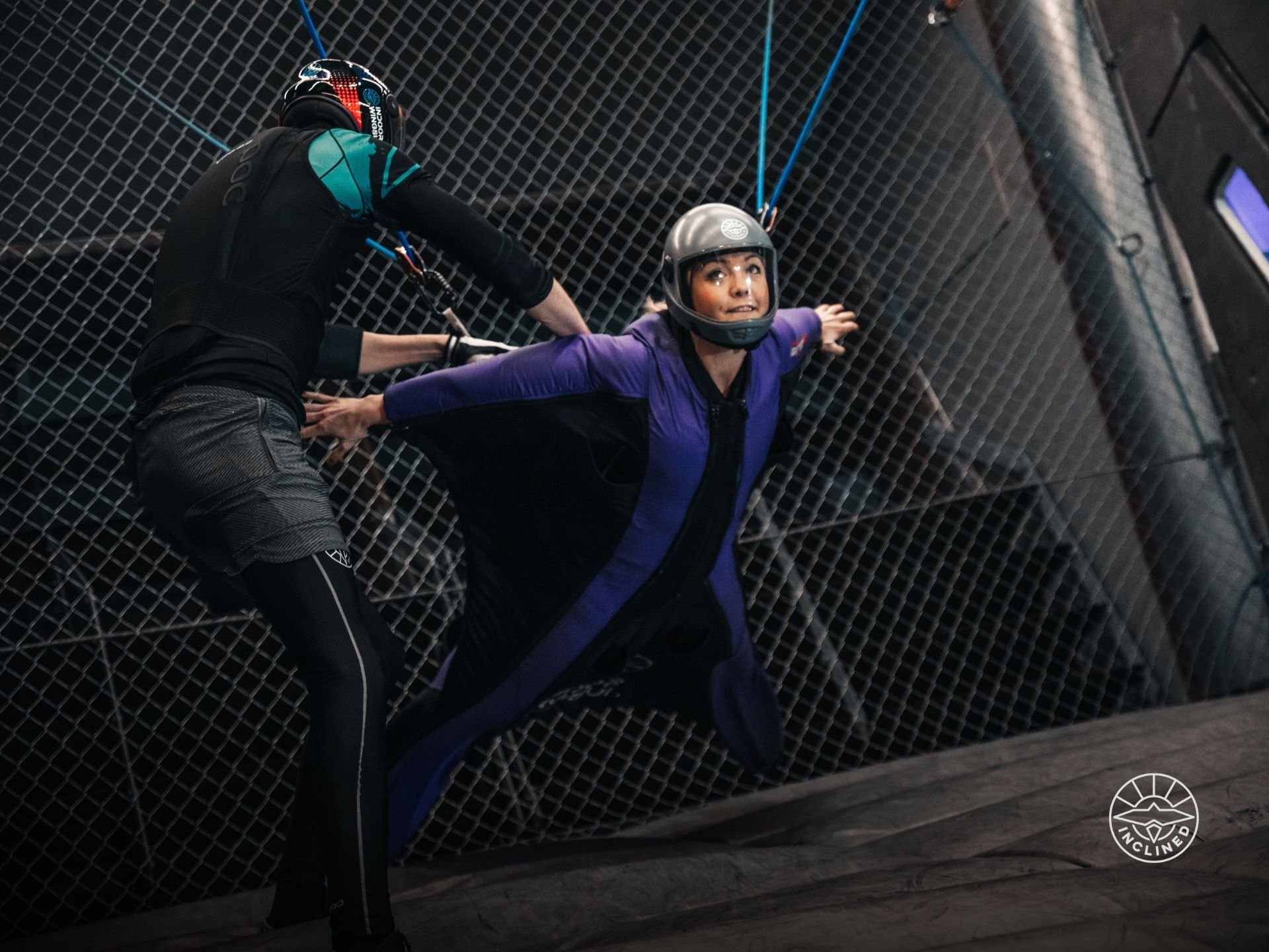 Wingsuit flyer glides forward in tunnel simulating real BASE flight, unlike vertical wind tunnels.